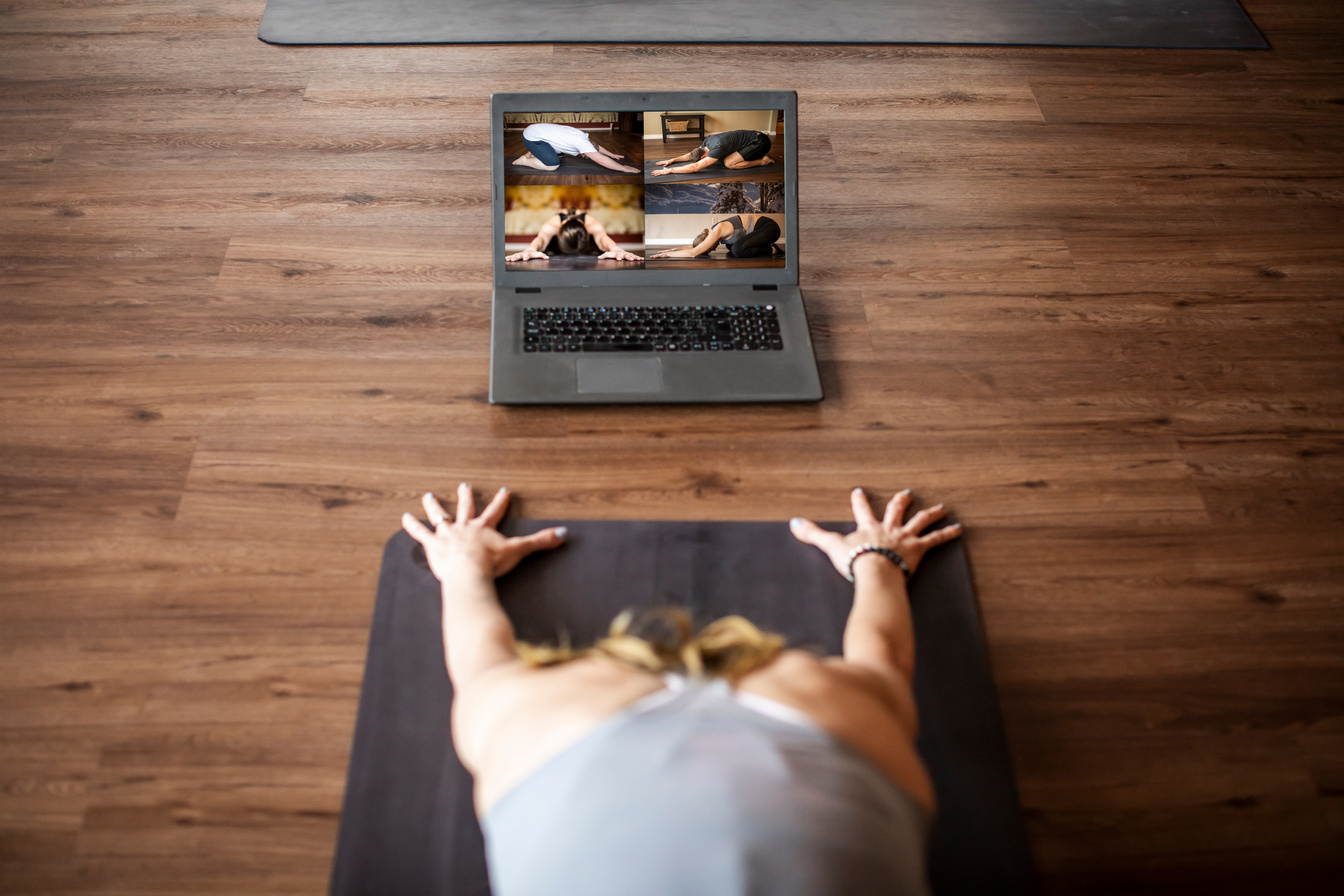 Yoga instructor teaching online class from studio.