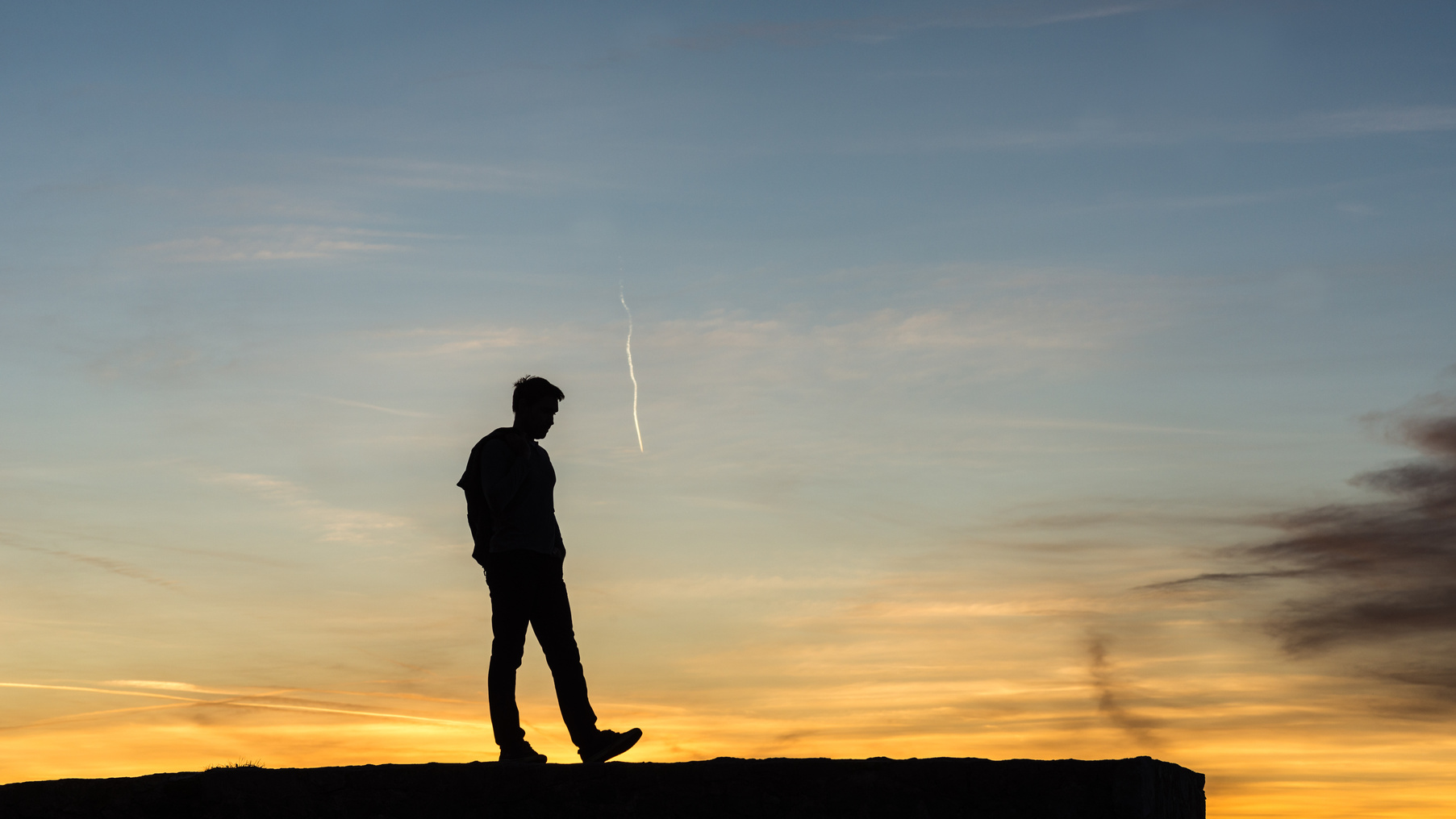 Man Walking on Rock Wall