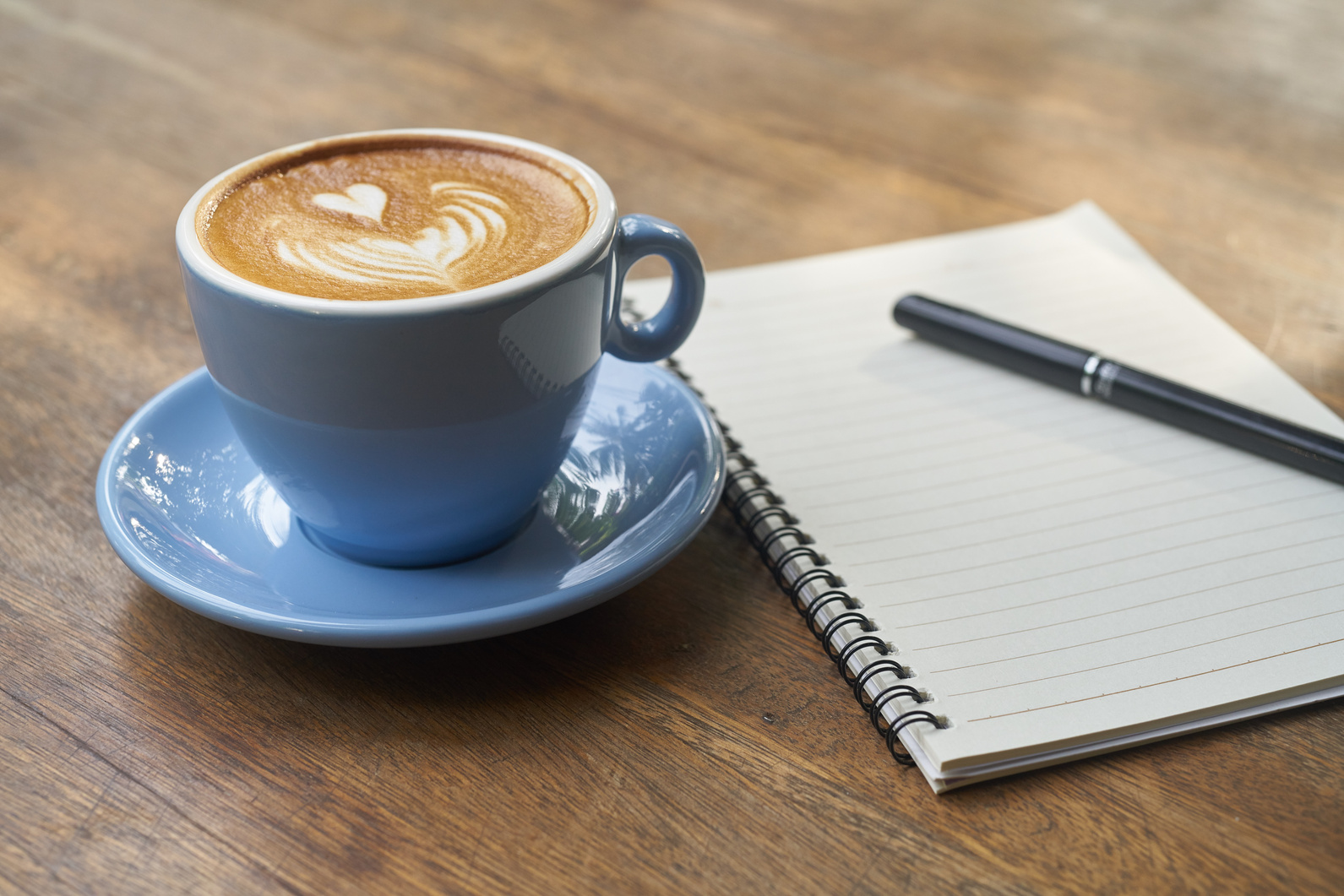 Coffee and Notebook on a Wooden Table